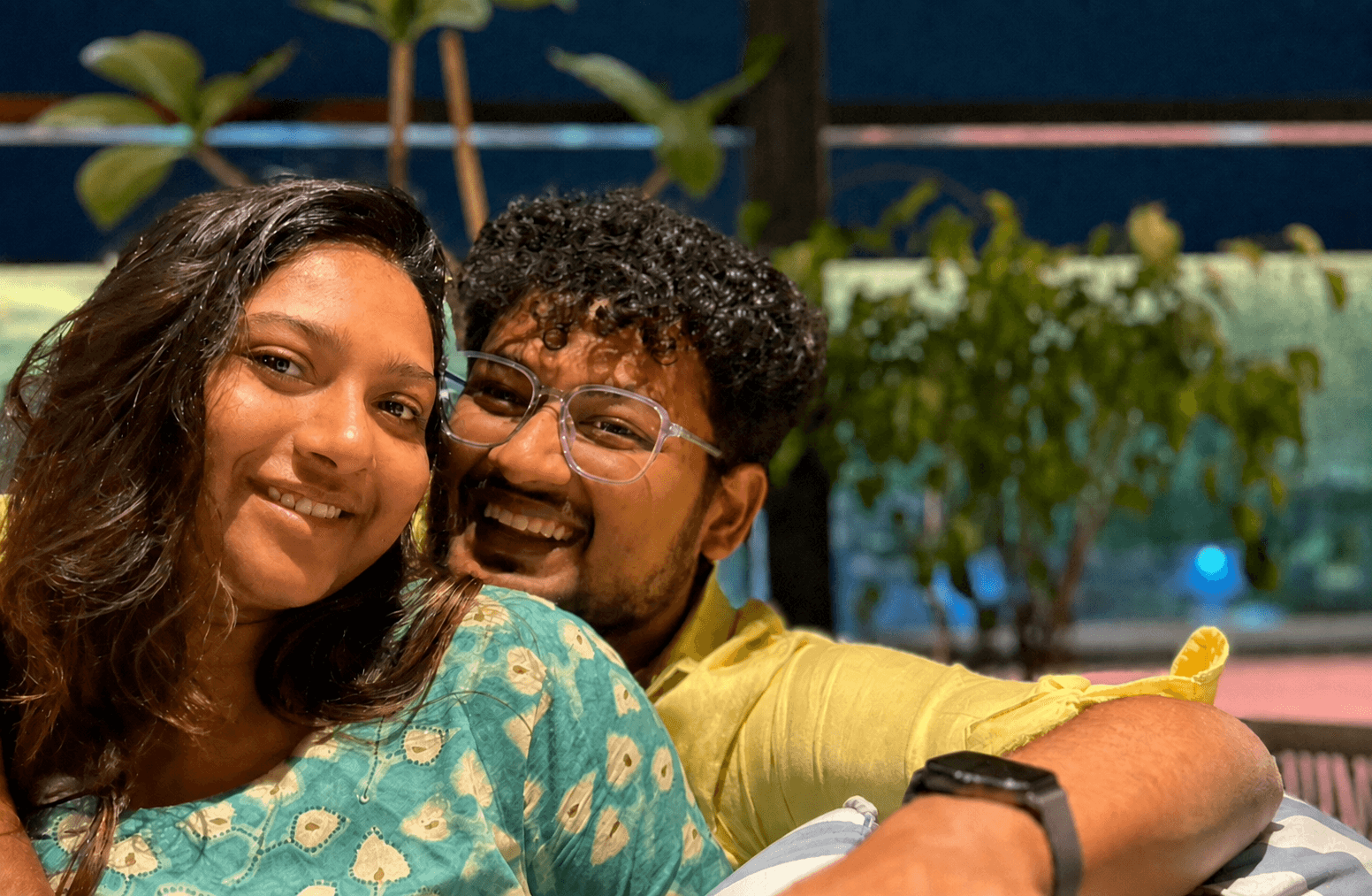 Rajshree and Deepesh smiling together outdoors