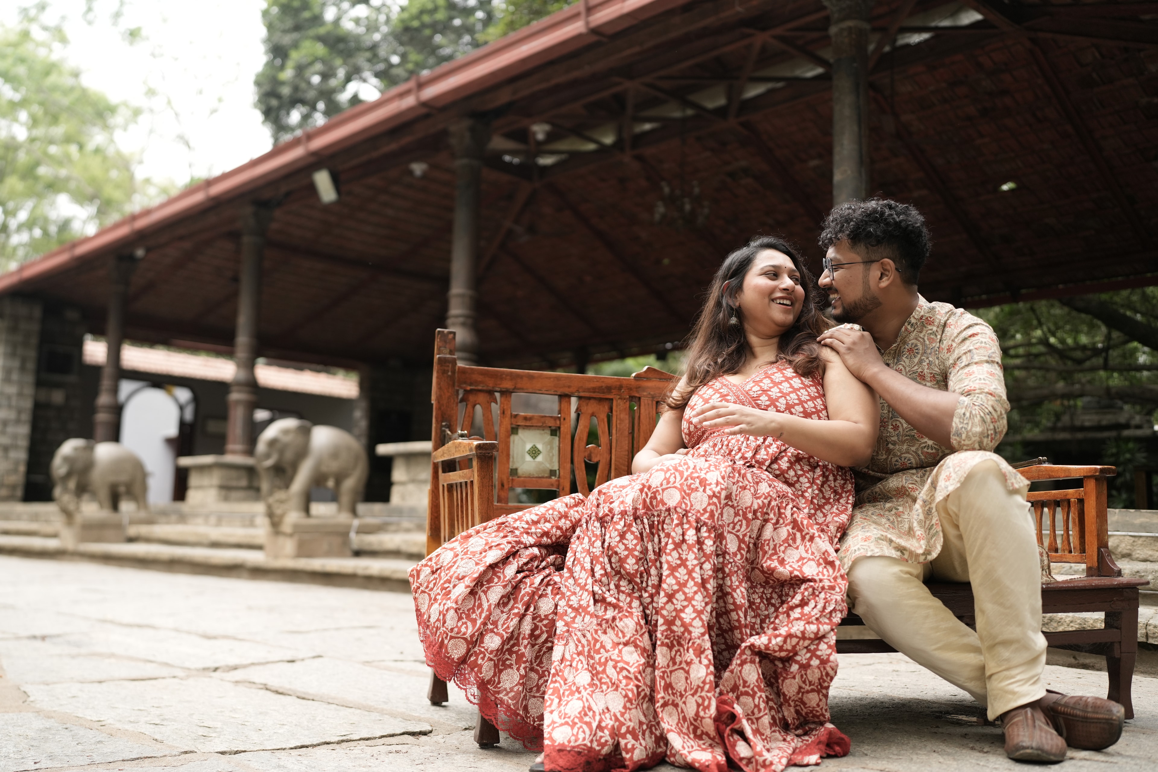 Rajshree and Deepesh smiling together on a bench